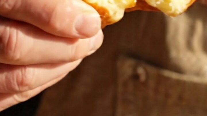 A close-up of a warm Belgian Liège waffle showing the texture of the caramelized sugar.