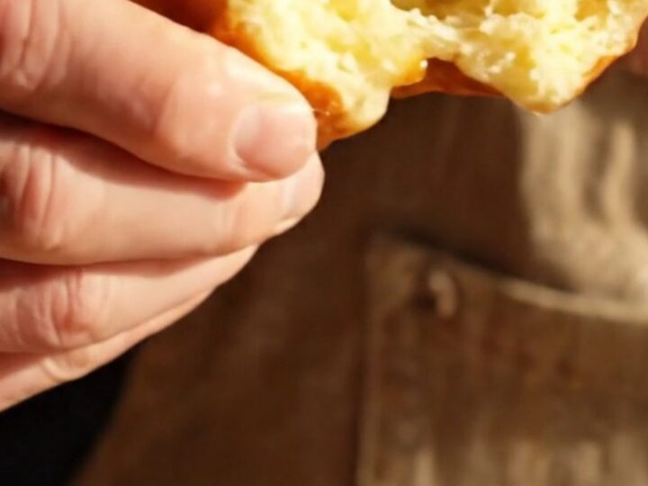A close-up of a warm Belgian Liège waffle showing the texture of the caramelized sugar.