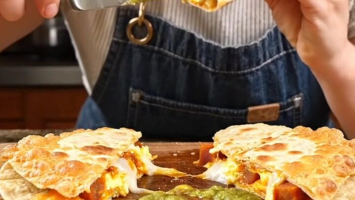 A crispy, golden-brown Parmesan-crusted quesadilla being pulled apart to reveal a gooey, cheesy interior.