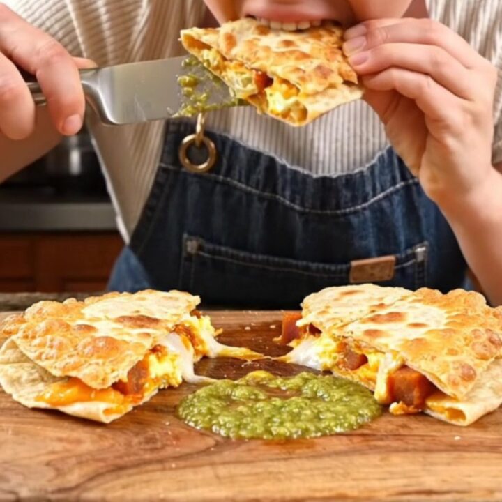 A crispy, golden-brown Parmesan-crusted quesadilla being pulled apart to reveal a gooey, cheesy interior.