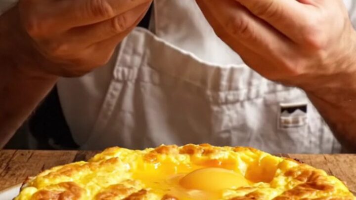 A thick, golden wedge of Spanish tortilla showing a creamy, custardy interior with tender potato slices.