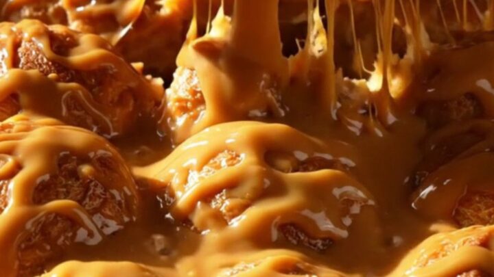 A steaming pull-apart brioche monkey bread in a cast-iron skillet with glossy butterscotch glaze.