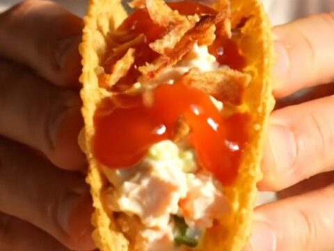 Crispy golden wonton taco filled with crab rangoon cream cheese and glossy sweet chili sauce.