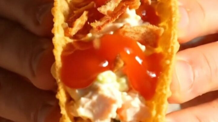 Crispy golden wonton taco filled with crab rangoon cream cheese and glossy sweet chili sauce.