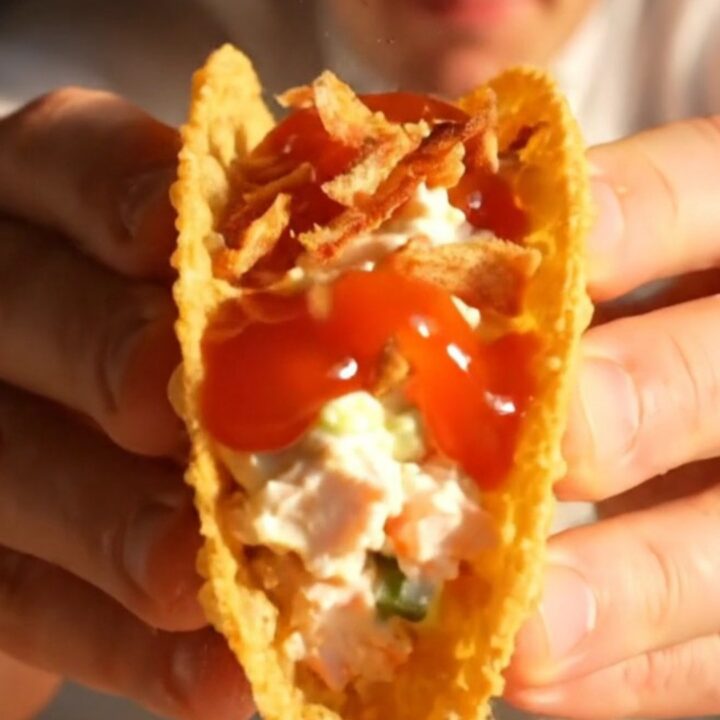 Crispy golden wonton taco filled with crab rangoon cream cheese and glossy sweet chili sauce.