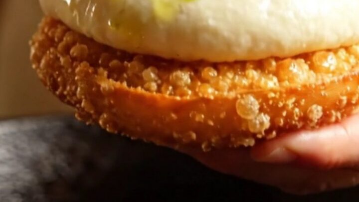 Golden pan-seared chicken and shiitake baozi torn open showing steaming savory filling and crispy base.