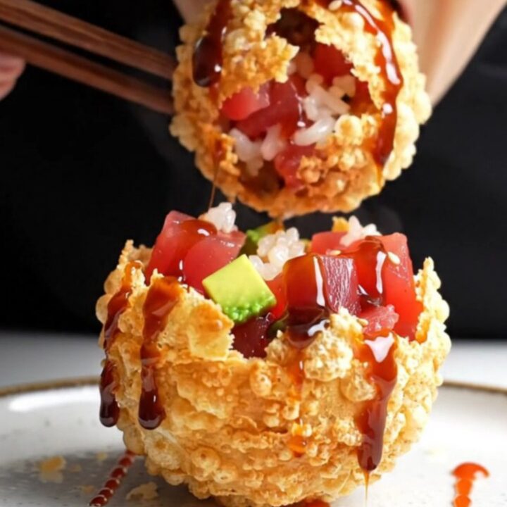 Golden, crispy air-fried rice paper poke bombs drizzled with dark unagi sauce and bright red sriracha dots.