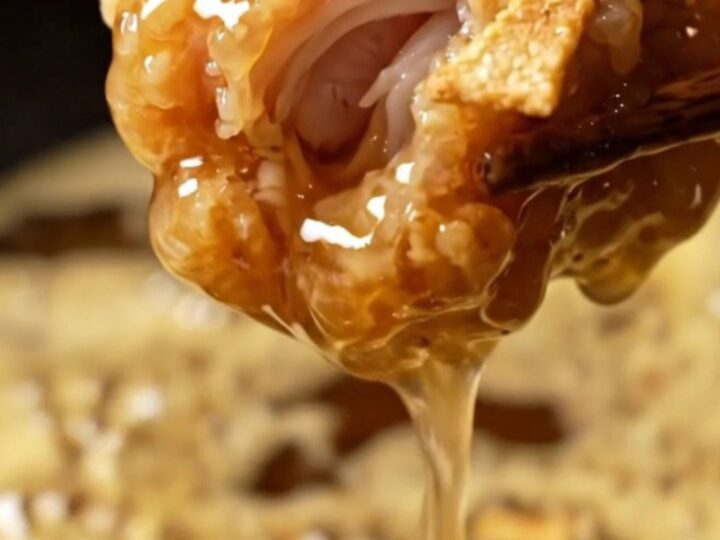 Close up shot of crispy golden honey butter garlic chicken tenders glistening under warm lighting.