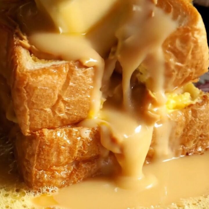 A close-up shot of golden-brown Hong Kong French toast with peanut butter oozing from the center.