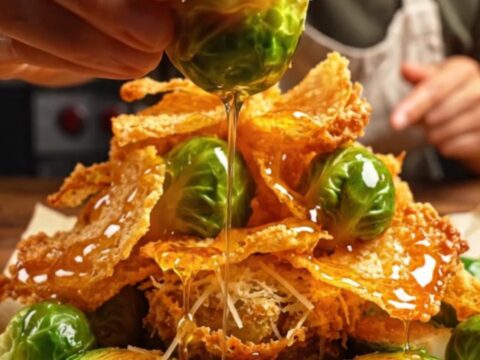 Crispy smashed Brussels sprouts with a golden parmesan crust on a rustic table.