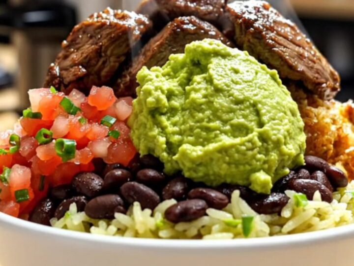 A close-up shot of shredded beef barbacoa in a black slow cooker, with steam rising and vibrant colors.
