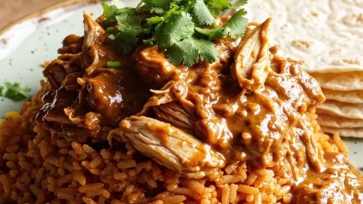 A rustic cream slow cooker filled with creamy shredded chicken, roasted poblano peppers, and melted Monterey Jack cheese.