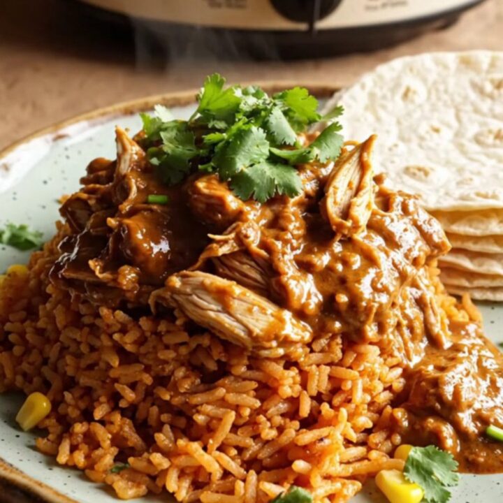A rustic cream slow cooker filled with creamy shredded chicken, roasted poblano peppers, and melted Monterey Jack cheese.