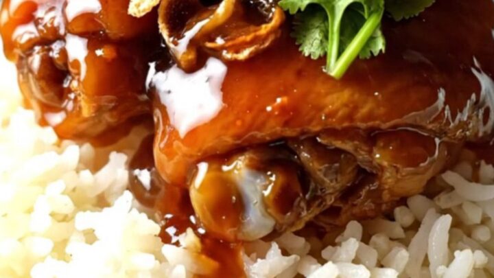 Sticky tamarind glazed shredded chicken served over jasmine rice in a ceramic bowl.