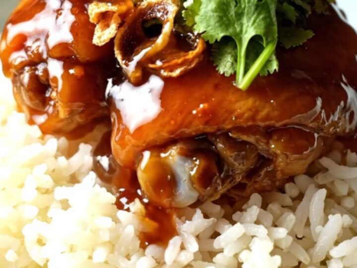 Sticky tamarind glazed shredded chicken served over jasmine rice in a ceramic bowl.