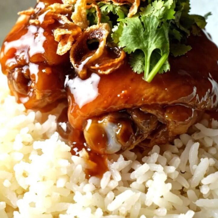 Sticky tamarind glazed shredded chicken served over jasmine rice in a ceramic bowl.