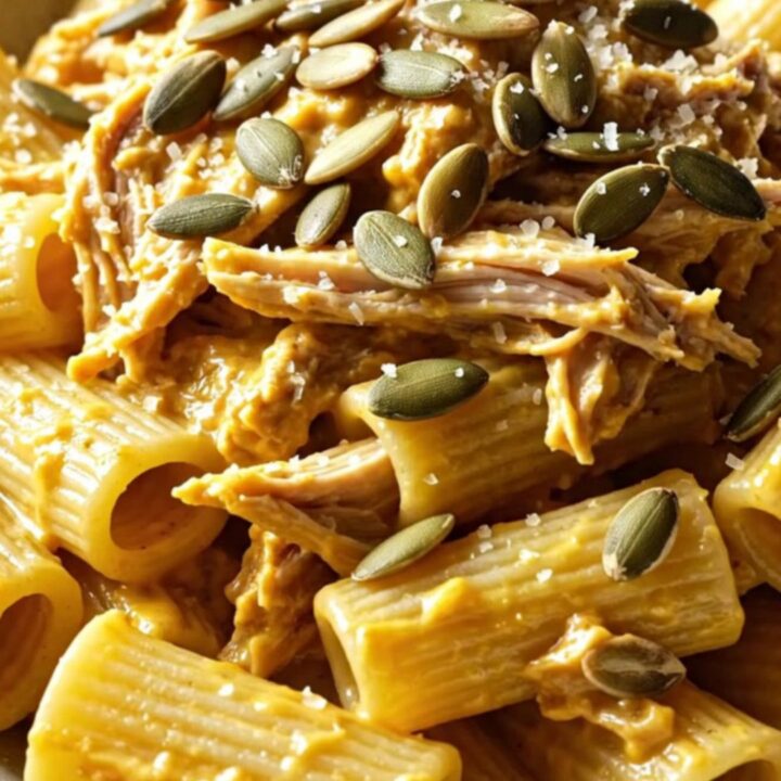 A warm, rustic bowl of creamy butternut squash and sage pasta with shredded chicken.
