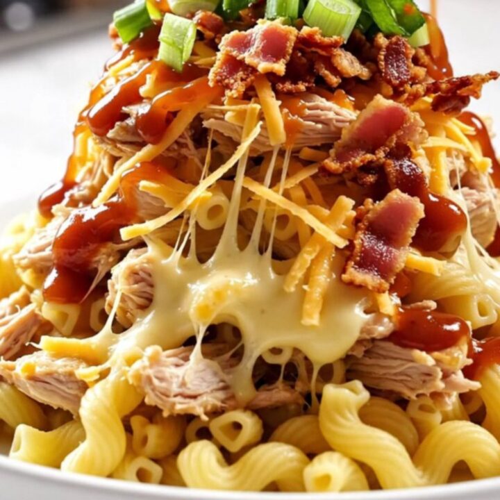 A close-up of a creamy Hawaiian BBQ chicken pasta bake served in a white ceramic bowl.