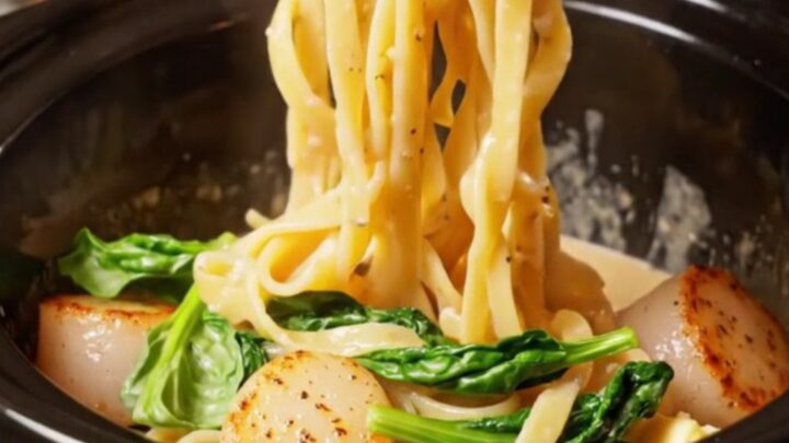 A close-up of a bowl filled with fettuccine in a creamy champagne sauce