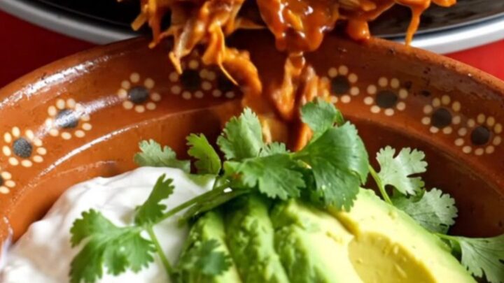 A warm Crockpot filled with golden-brown cornbread-topped pulled pork casserole.