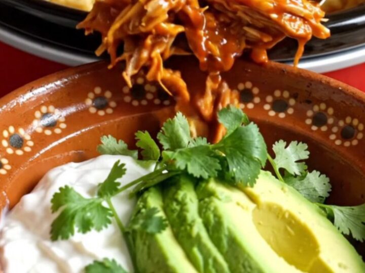 A warm Crockpot filled with golden-brown cornbread-topped pulled pork casserole.