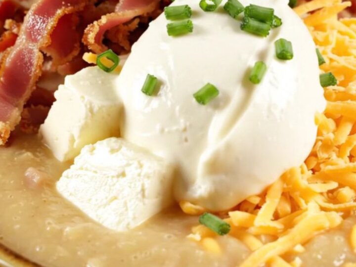 A steaming bowl of creamy loaded baked potato chowder topped with crispy bacon, cheddar, and chives.