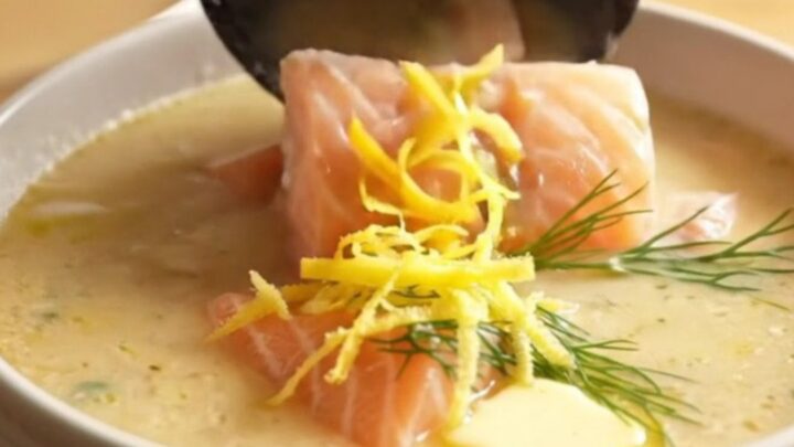 A close-up of a matte-slate ceramic slow cooker filled with creamy Nordic salmon and potato chowder.