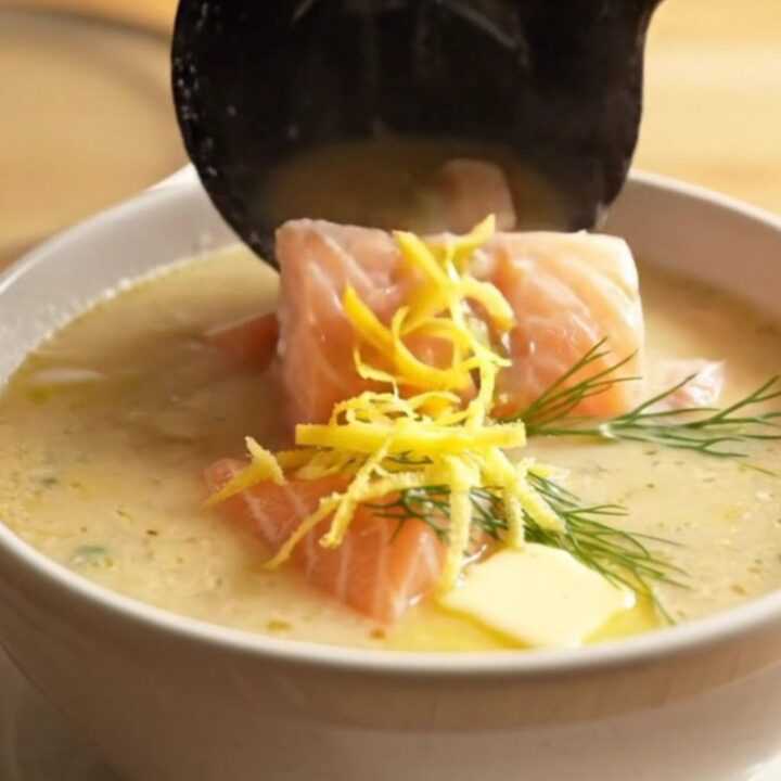 A close-up of a matte-slate ceramic slow cooker filled with creamy Nordic salmon and potato chowder.