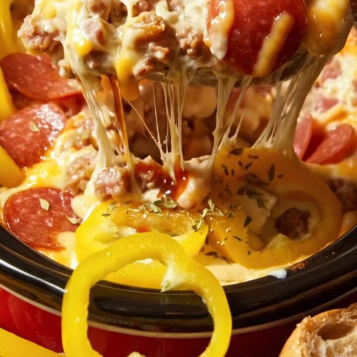 A close-up view of a toasted Italian bread wedge dipping into a creamy