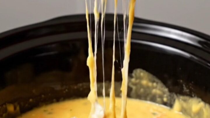 A warm, golden lobster thermidor fondue in a slow cooker, served with toasted brioche points.