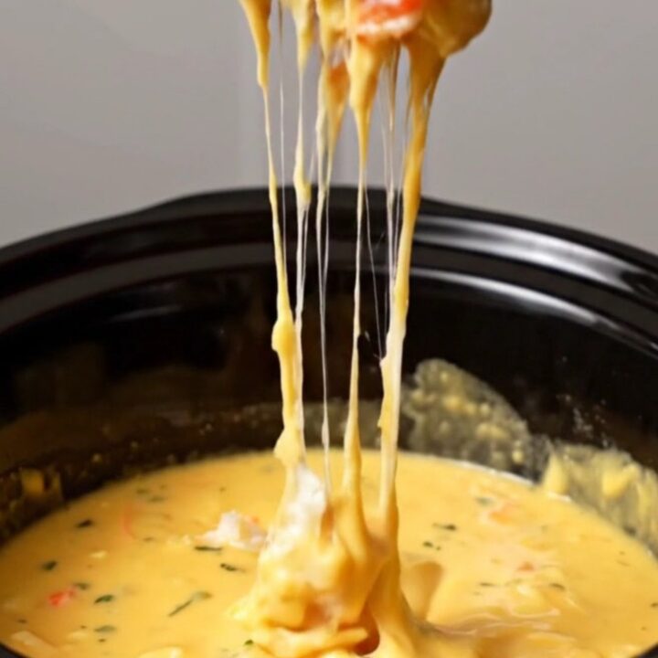 A warm, golden lobster thermidor fondue in a slow cooker, served with toasted brioche points.