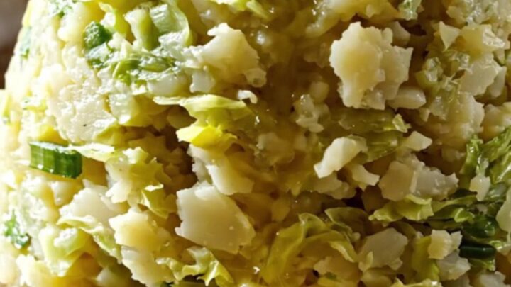 A rustic slow cooker filled with creamy mashed potatoes swirled with cabbage and leeks