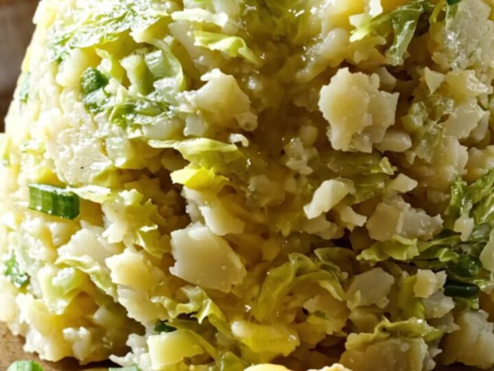 A rustic slow cooker filled with creamy mashed potatoes swirled with cabbage and leeks