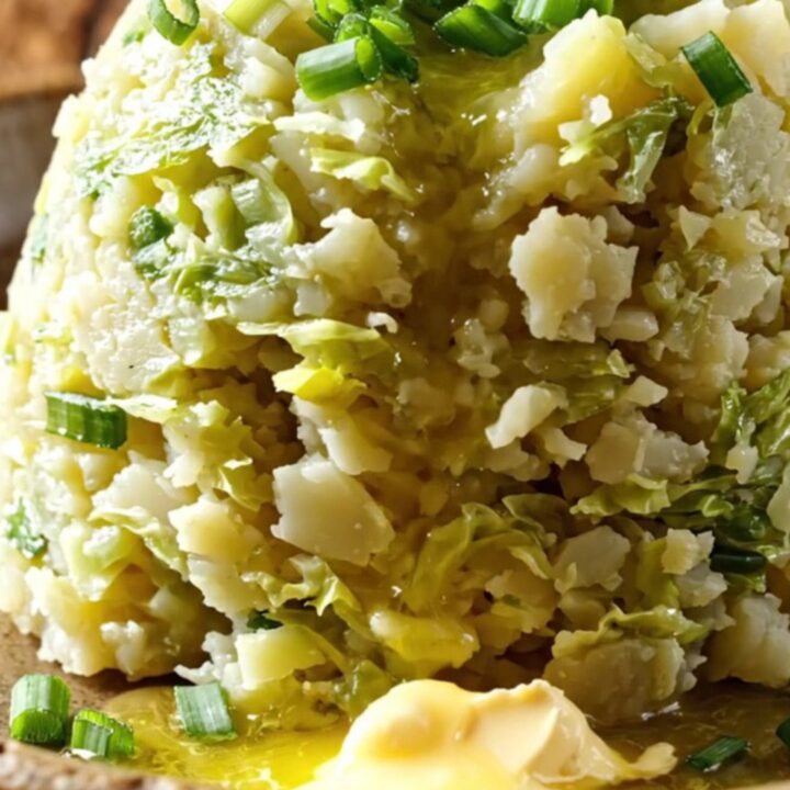 A rustic slow cooker filled with creamy mashed potatoes swirled with cabbage and leeks