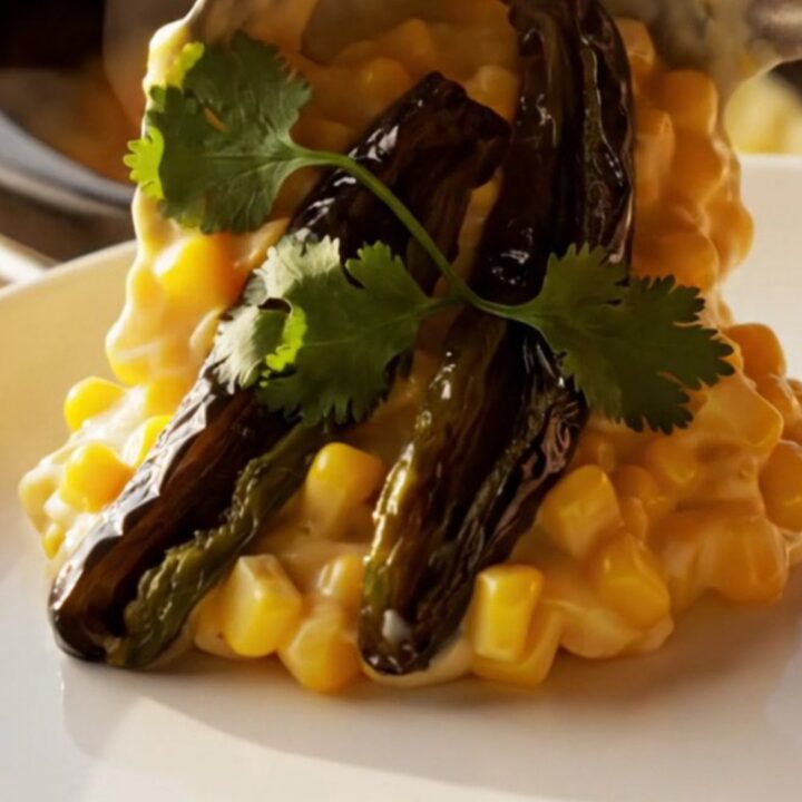 A golden, bubbling roasted poblano and white cheddar corn pudding in a copper Crockpot.