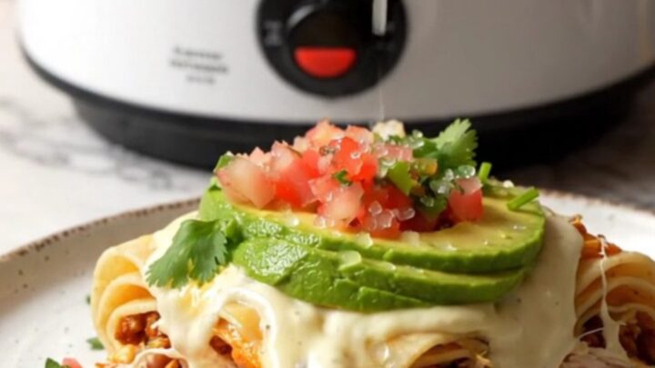 A steaming, gooey slice of white queso and rotisserie chicken lasagna on a plate.