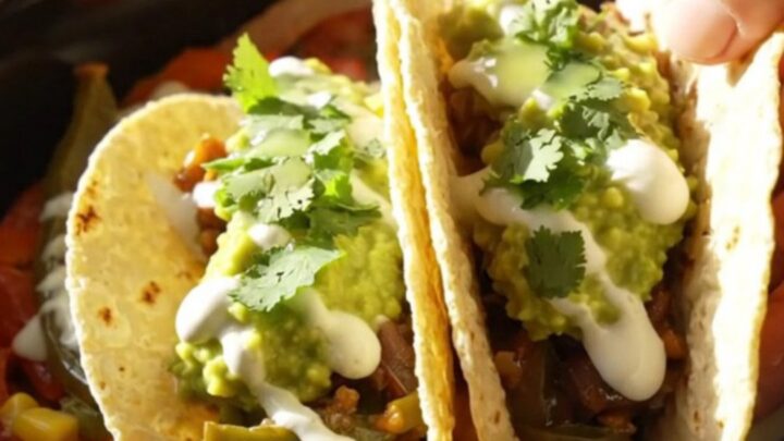 A vibrant slow-cooker filled with roasted poblano peppers, red bell peppers, corn