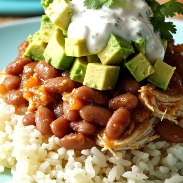 A bright turquoise Crockpot filled with shredded chicken, pinto beans, and melted cheese in a sunny kitchen.