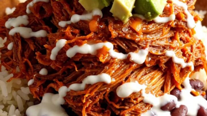 A vibrant burrito bowl featuring tender shredded pork al pastor, charred pineapple, and melted cheese.