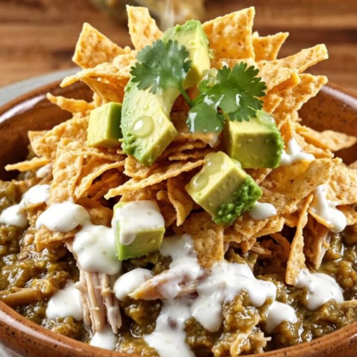 A close-up of a creamy green poblano and white cheddar chicken stew in a ceramic bowl with toppings.