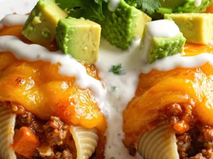 A close-up of jumbo pasta shells stuffed with seasoned beef and cream cheese